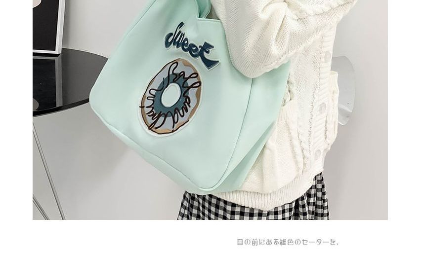 Schultertasche mit Donut-Stickerei