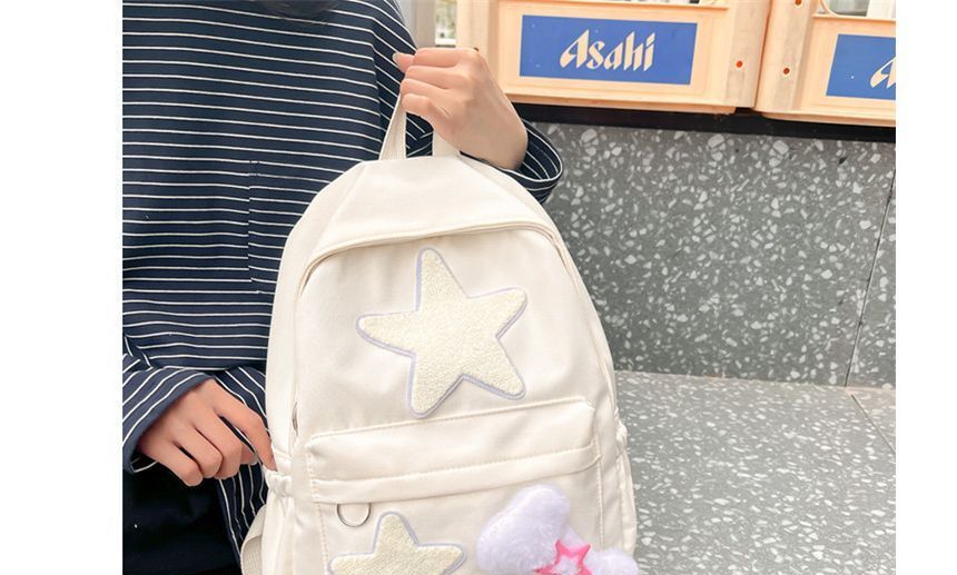 Rucksack mit mehreren Taschen und Stern-Applikationen