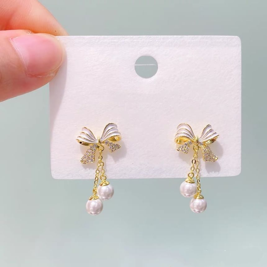 Boucles d'oreilles pendantes en fausses perles avec nœud en strass