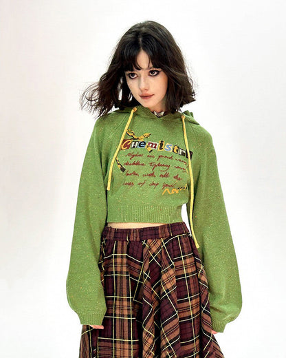 This preppy cropped hoodie in green features a cute 'Chemistry' print, ruffled collar details, and a knit construction