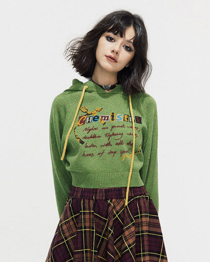 This preppy cropped hoodie in green features a cute 'Chemistry' print, ruffled collar details, and a knit construction
