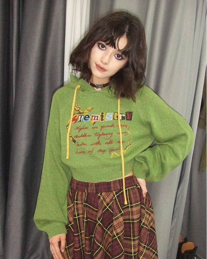This preppy cropped hoodie in green features a cute 'Chemistry' print, ruffled collar details, and a knit construction