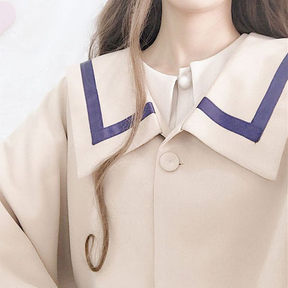 Cape mit Kontrastbesatz / Langärmliges, schlichtes Midikleid in A-Linie mit Kragen